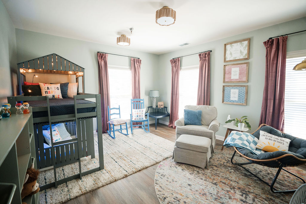 Children's counseling room with a house-shaped loft bed and reading chair