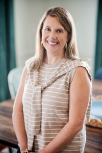Julie Johnson, LCSW, smiling in the group therapy room at The Storyhouse Counseling Center