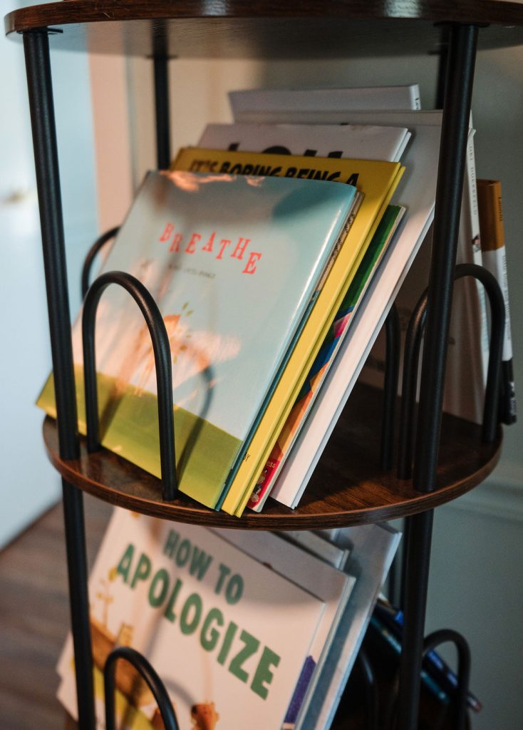 Cart of therapeutic children's books at The Storyhouse Counseling Center