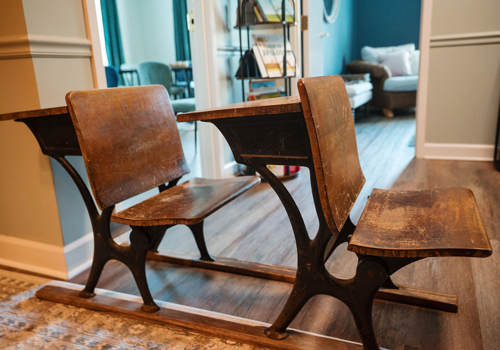 Vintage school desks in a Storyhouse Counseling Center hallway